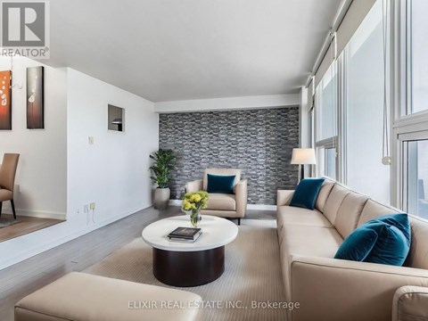 A modern living room with a stone wall and a large window.