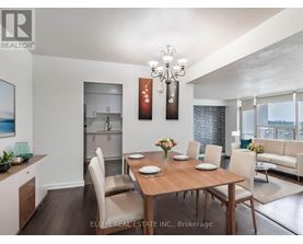 A dining room with a wooden table set for six.