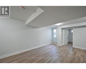 A room with a wooden floor and white walls.