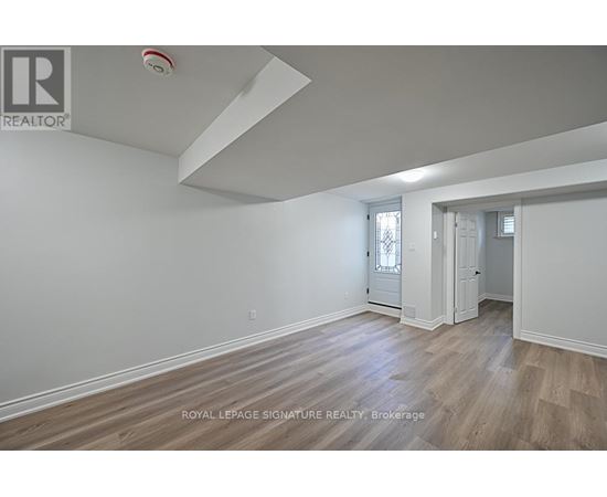 A room with a wooden floor and white walls.