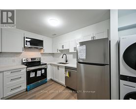 A kitchen with a stainless steel refrigerator and oven.