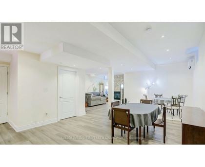 A dining room with a table set for six.