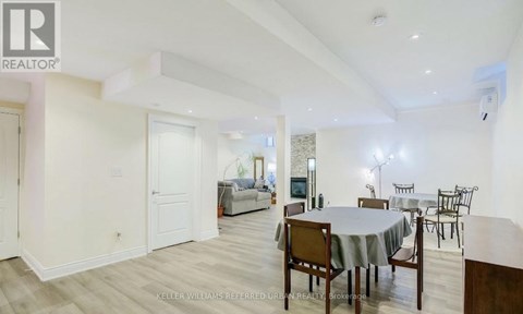 A dining room with a table set for six.