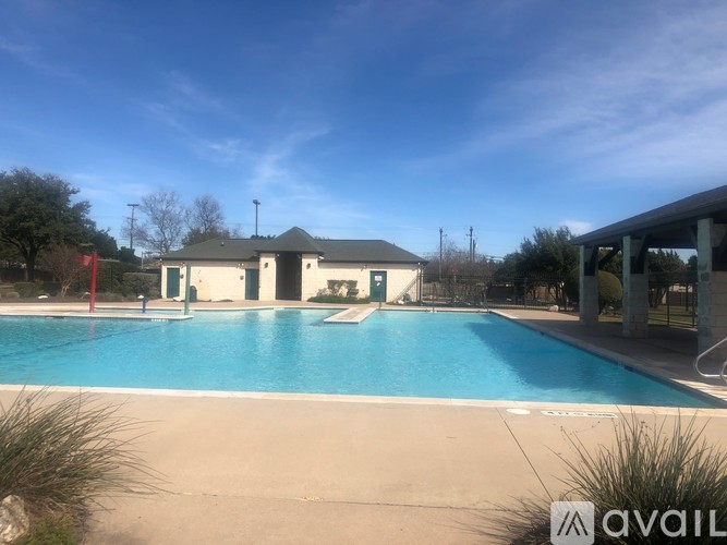 A large outdoor swimming pool with a building in the background.