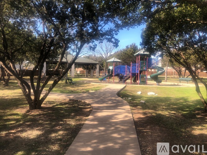 A park with a playground and a walking path.