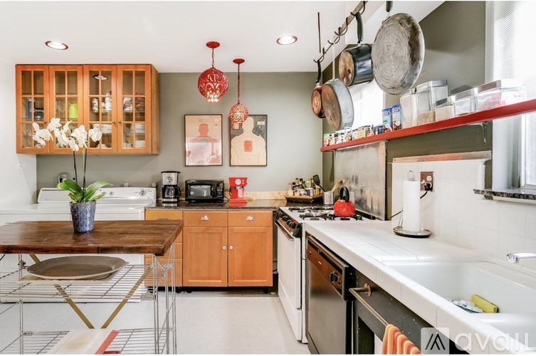 A kitchen with a wooden table and a white counter.