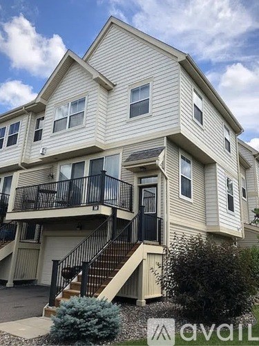 A two-story house with a balcony on the second floor.