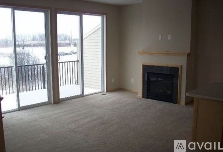A living room with a fireplace and sliding glass doors.