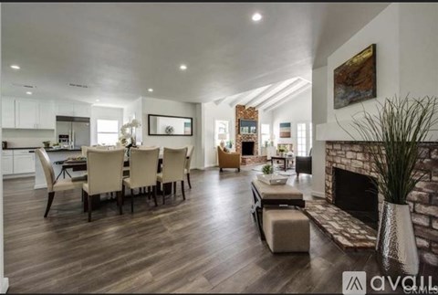 A modern living room with a fireplace and a dining table set up.