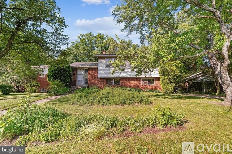A house with a garden in front of it is for sale.