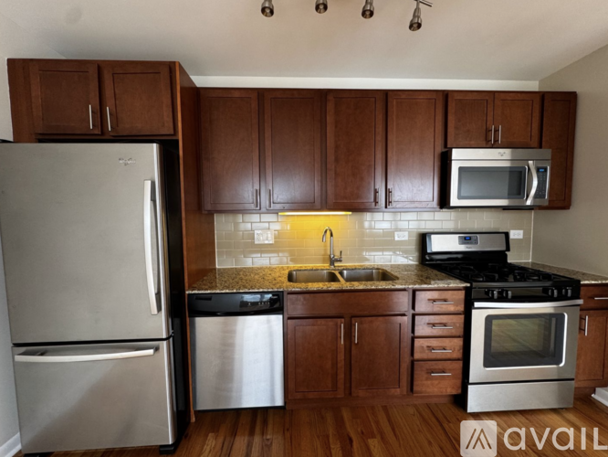 A kitchen with wooden cabinets and stainless steel appliances.
