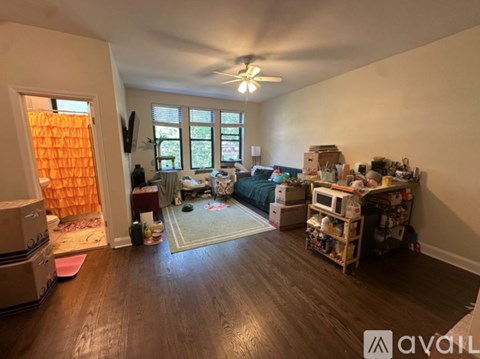 A room with a lot of boxes and furniture in it.