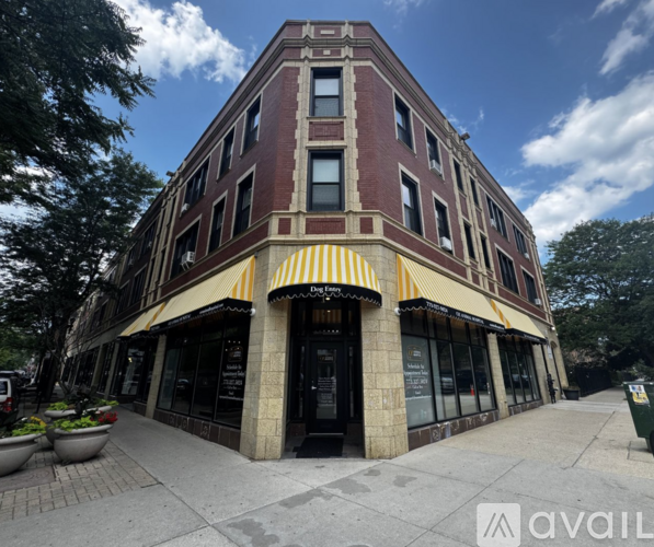 A building with a striped awning on the front.