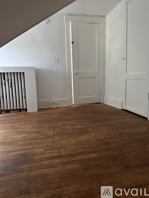 A room with wooden floors and white walls.