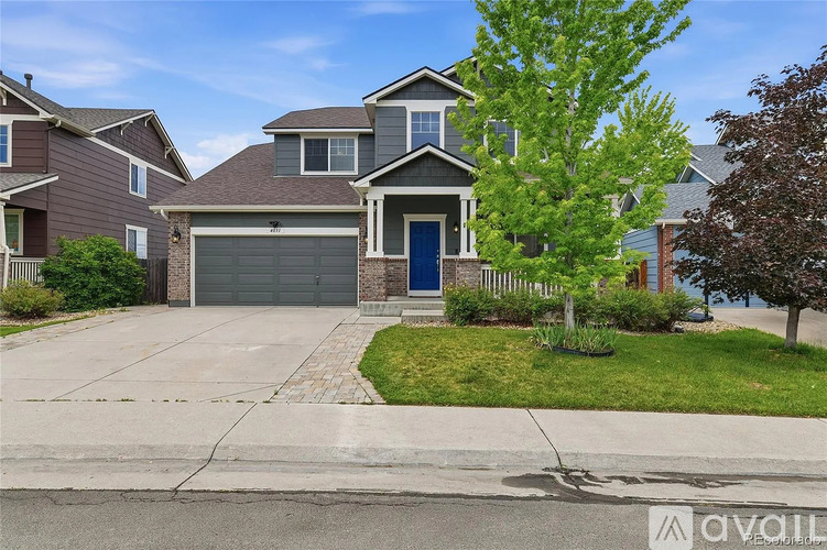 A house with a blue door is for sale.