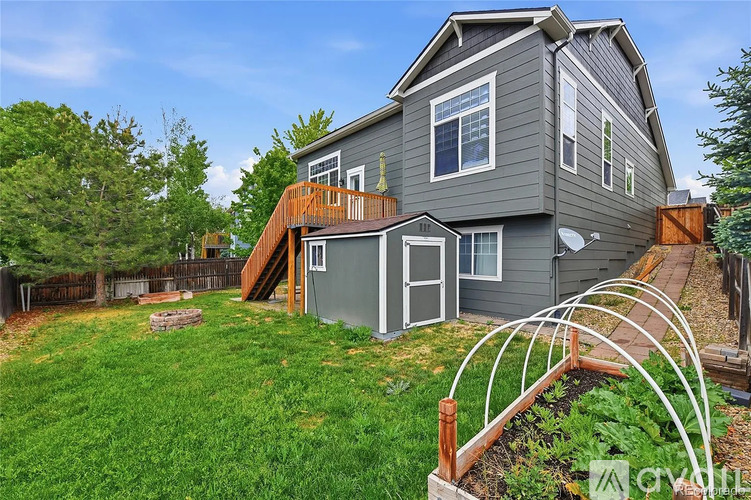 A house with a grey exterior and a wooden deck.