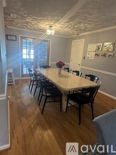 A dining room with a table and chairs.