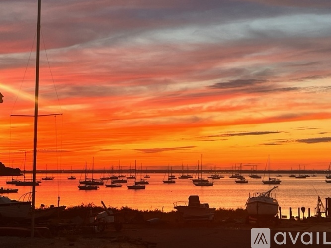 A beautiful sunset over a marina with boats docked in the water.