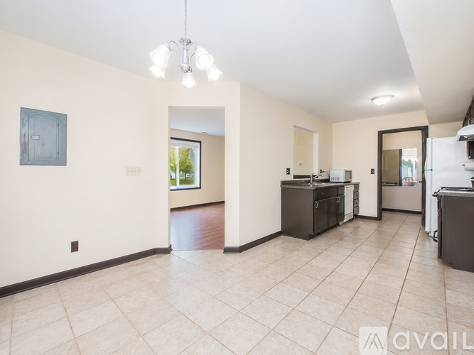 A spacious kitchen area with a dining table and chairs.