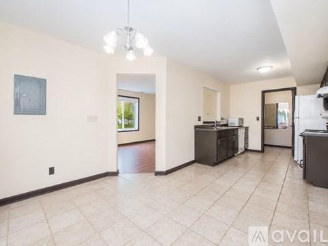 A spacious kitchen area with a dining table and chairs.