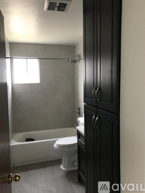 A bathroom with a toilet, sink, and shower.