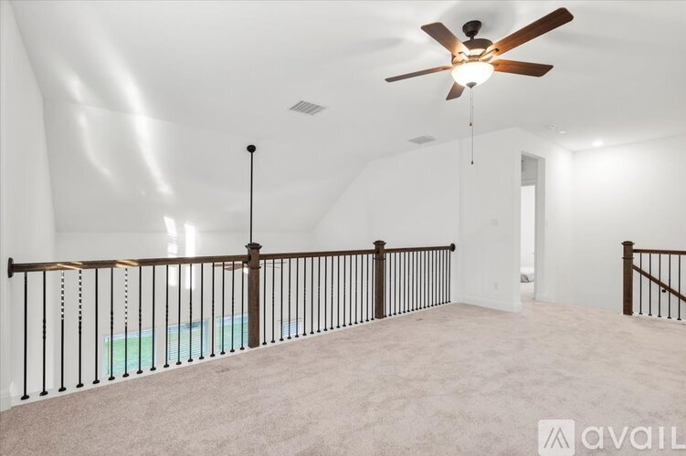 A room with a ceiling fan and a pool table.
