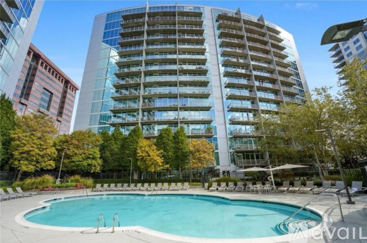 A large building with a pool in front of it.