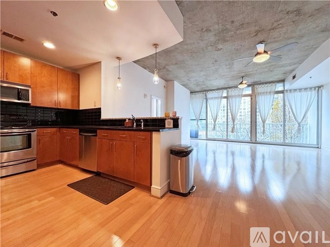 A kitchen with wooden cabinets and a black countertop.