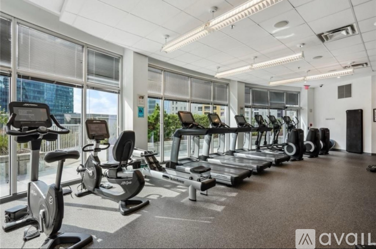 A gym with treadmills, exercise bikes, and elliptical machines.