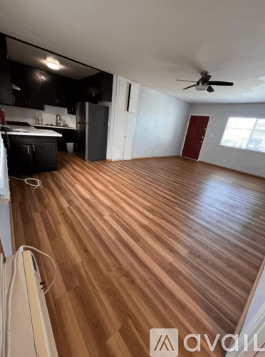 A room with wooden flooring and a ceiling fan.