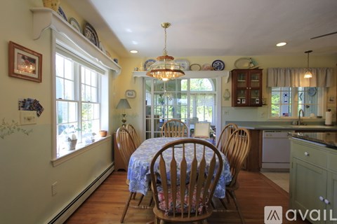 A dining room with a table set for four.
