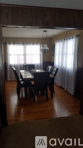 A dining room with a table set for six.