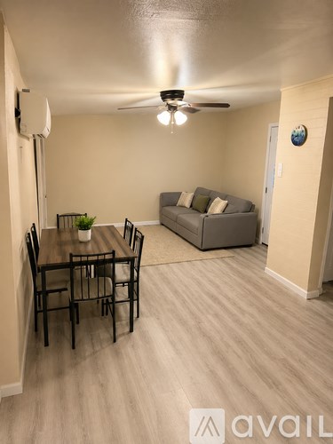A living room with a dining table and a couch.