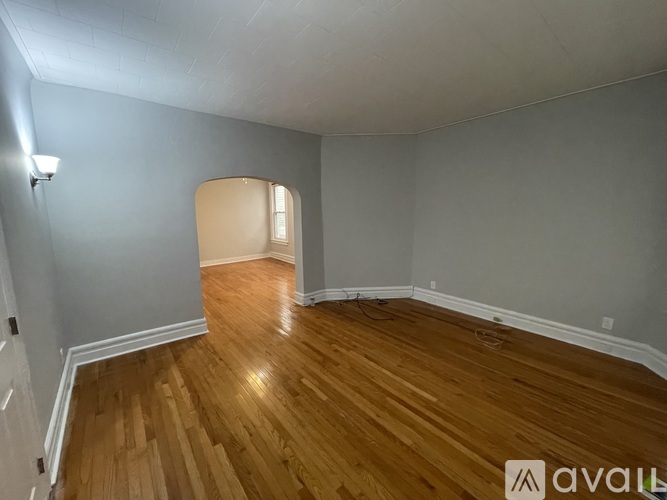 A room with wooden flooring and a white door.