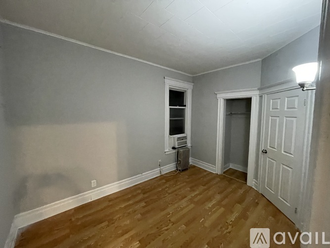 A room with wooden floors and white walls.