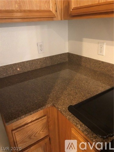 A kitchen counter with a black tray on it.