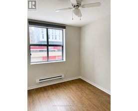 A room with a window and a fan.