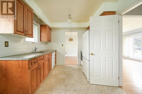 A kitchen with wooden cabinets and a white door.