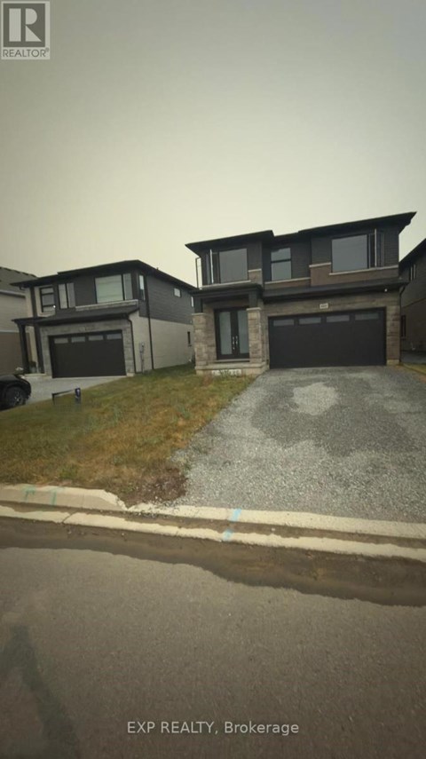A house with a grey garage door is shown in the image.