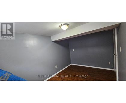 A room with a brokerage sign on the wall.