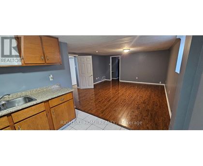 A kitchen with wooden cabinets and a sink.