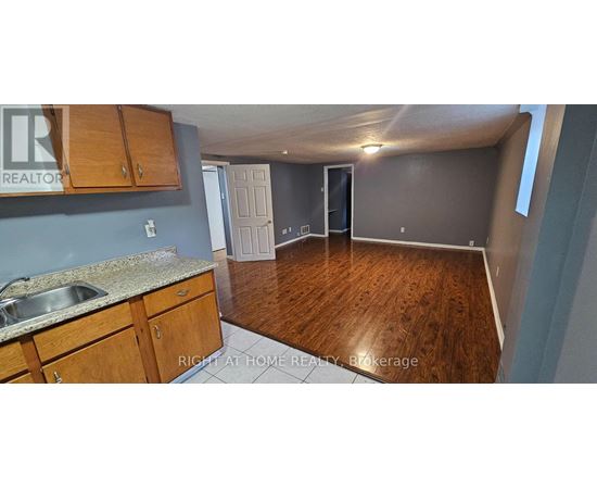A kitchen with wooden cabinets and a sink.