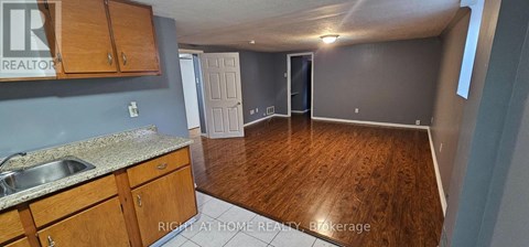 A kitchen with wooden cabinets and a sink.