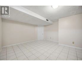 A spacious room with a door and a light on the ceiling.