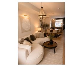 A white sofa with a coffee table in front of it.