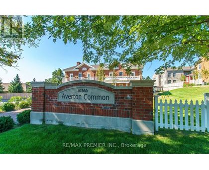 A brick sign that says Averton Common stands in front of a white picket fence.