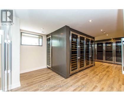 A room with a large metal cabinet and wooden flooring.