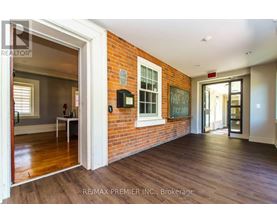 A room with a brick wall and wooden floors.