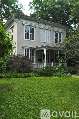 A house with a porch and a lawn in front.