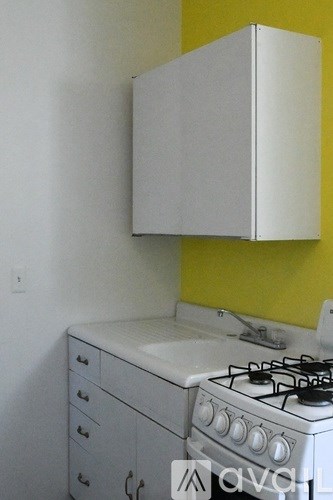 A white stove and cabinet in a kitchen.